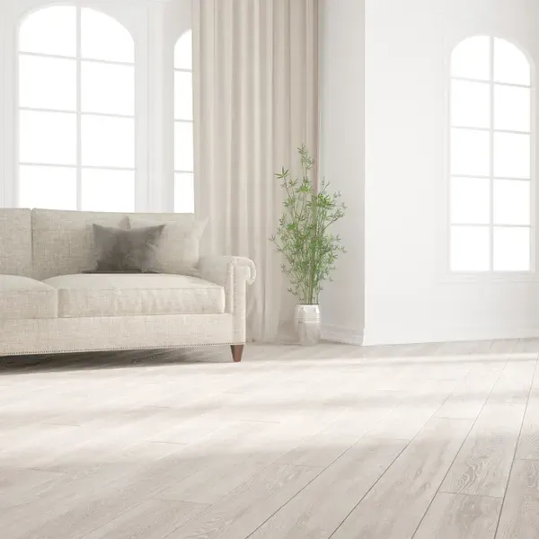 Bright living room with a light wood-look floor and a sofa (illustrative image)