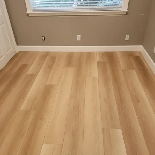 Light wood-look luxury vinyl plank floor in a bedroom in the East Bay